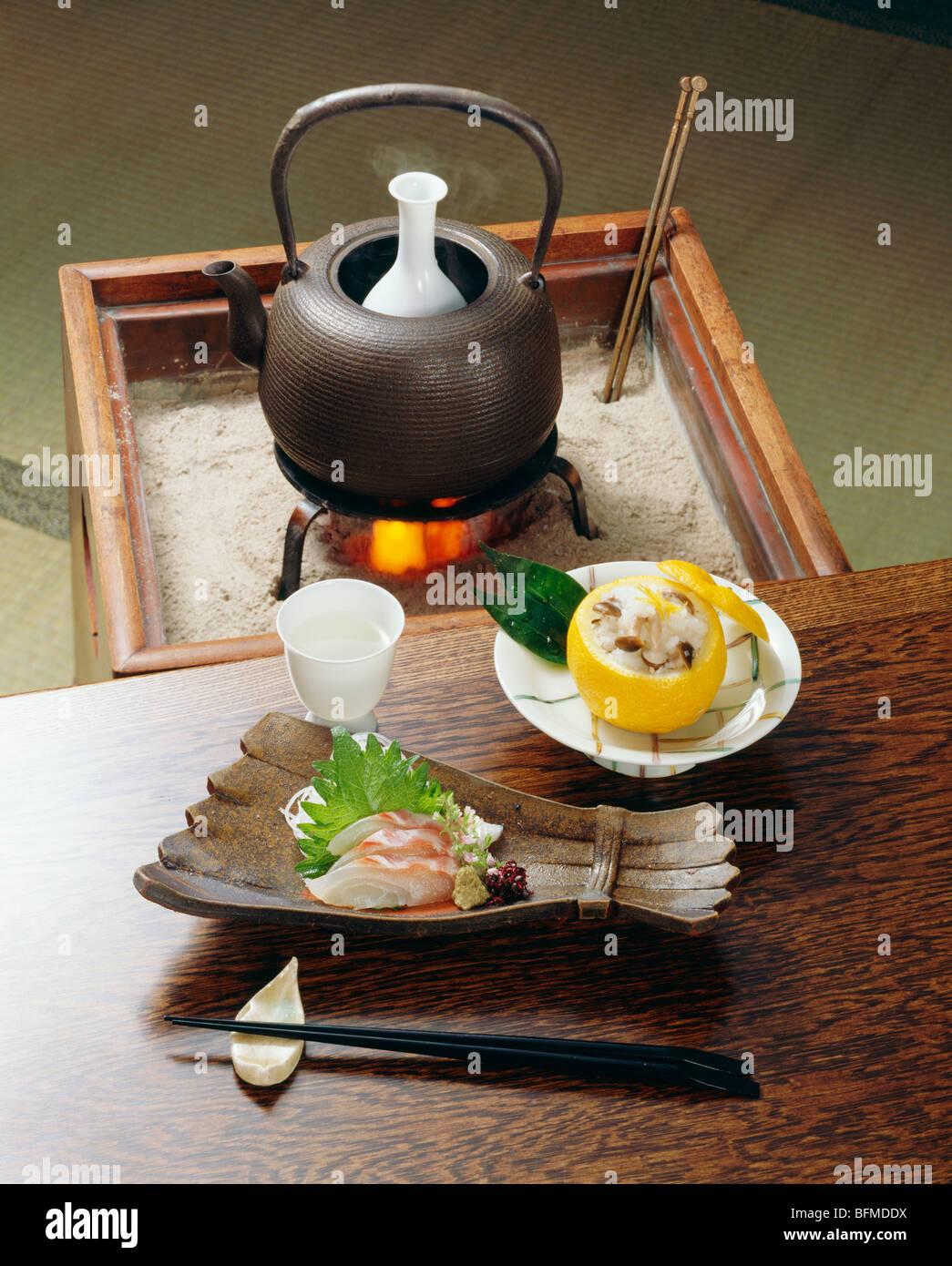 Sake and plate of sliced fish Stock Photo Alamy