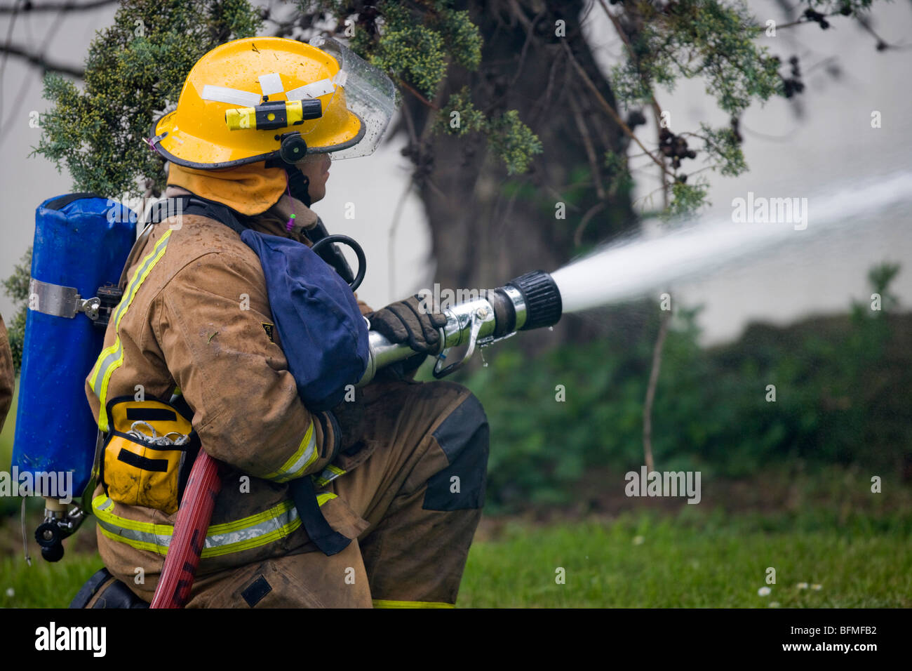 firefighter fighting fire with hose