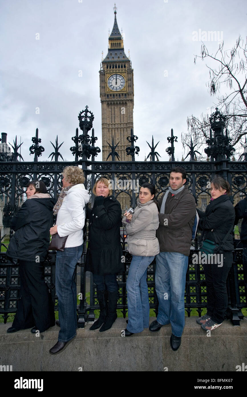 a crowd hanging on railings waiting for the new years parade opposite ...