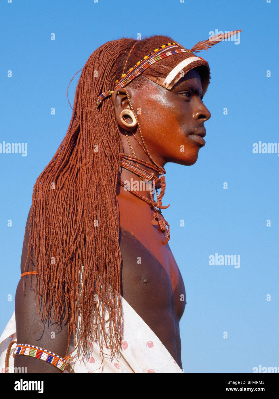 A Samburu warrior in traditional dress with long ochred hair. Stock Photo