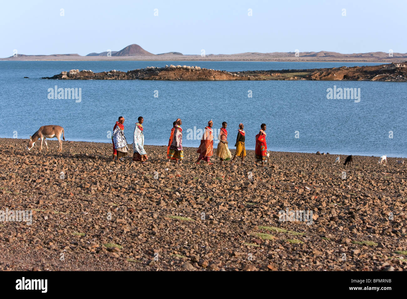 A group of El Molo women walk along the barren shoreline of Lake Turkana s El Molo Bay. Stock Photo