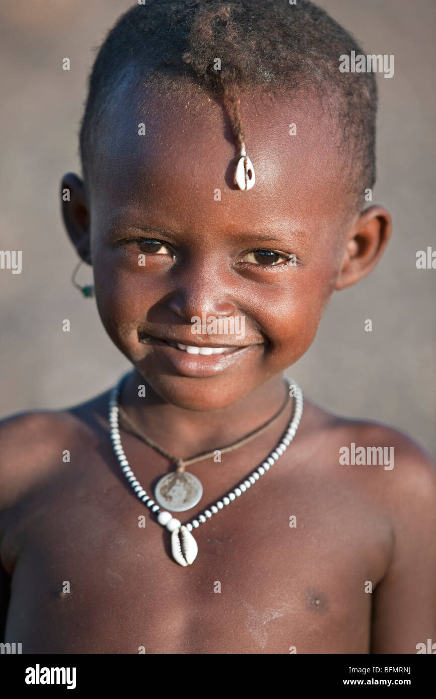 A happy El Molo girl. The cowrie in her hair is a good luck charm. Stock Photo