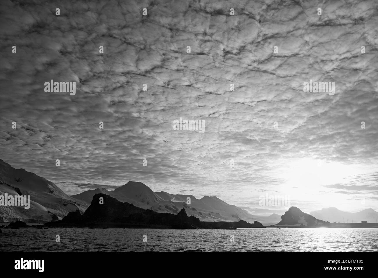 Antarctica, Antarctic Penisula, Half Moon Bay, a dramatic backdrop shelters the site of a seasonal Argentinan scientific base. Stock Photo