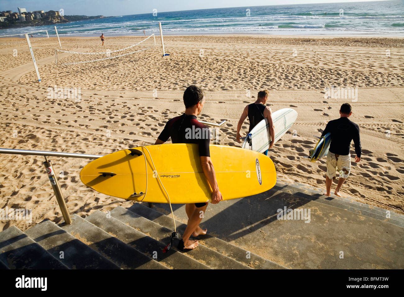 Australia, New South Wales, Sydney.  Surfers head for the water at Manly Beach. Stock Photo