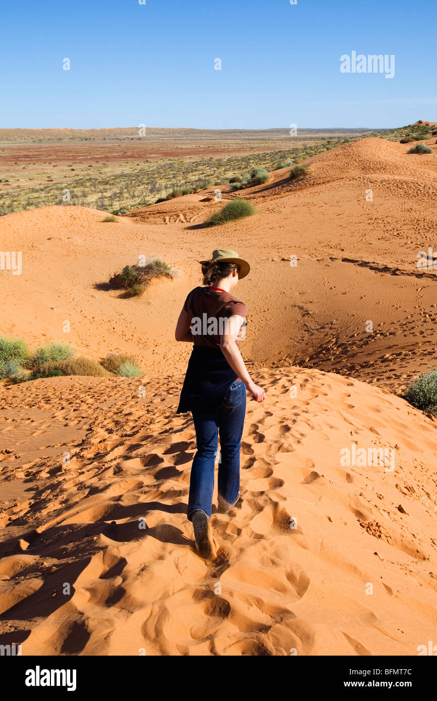 Australia, Queensland, Simpson Desert National Park, Birdsville. Running down a sand dune in the Simpson Desert.(MR) Stock Photo