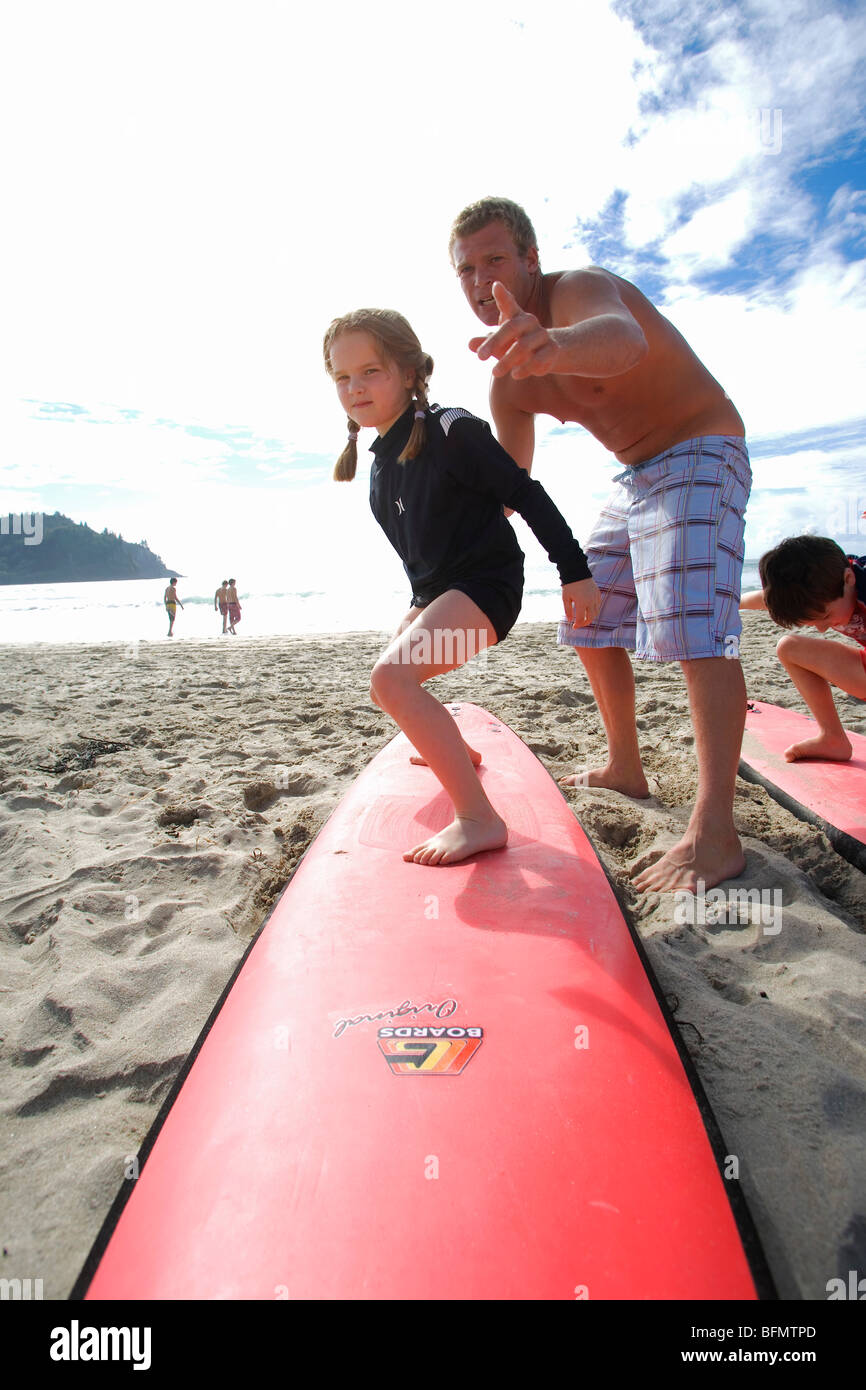 New Zealand, North Island, Coromandel Peninsula. Family surf lesson with Ricky Parker of Whangamata Surf School. (MR) Stock Photo