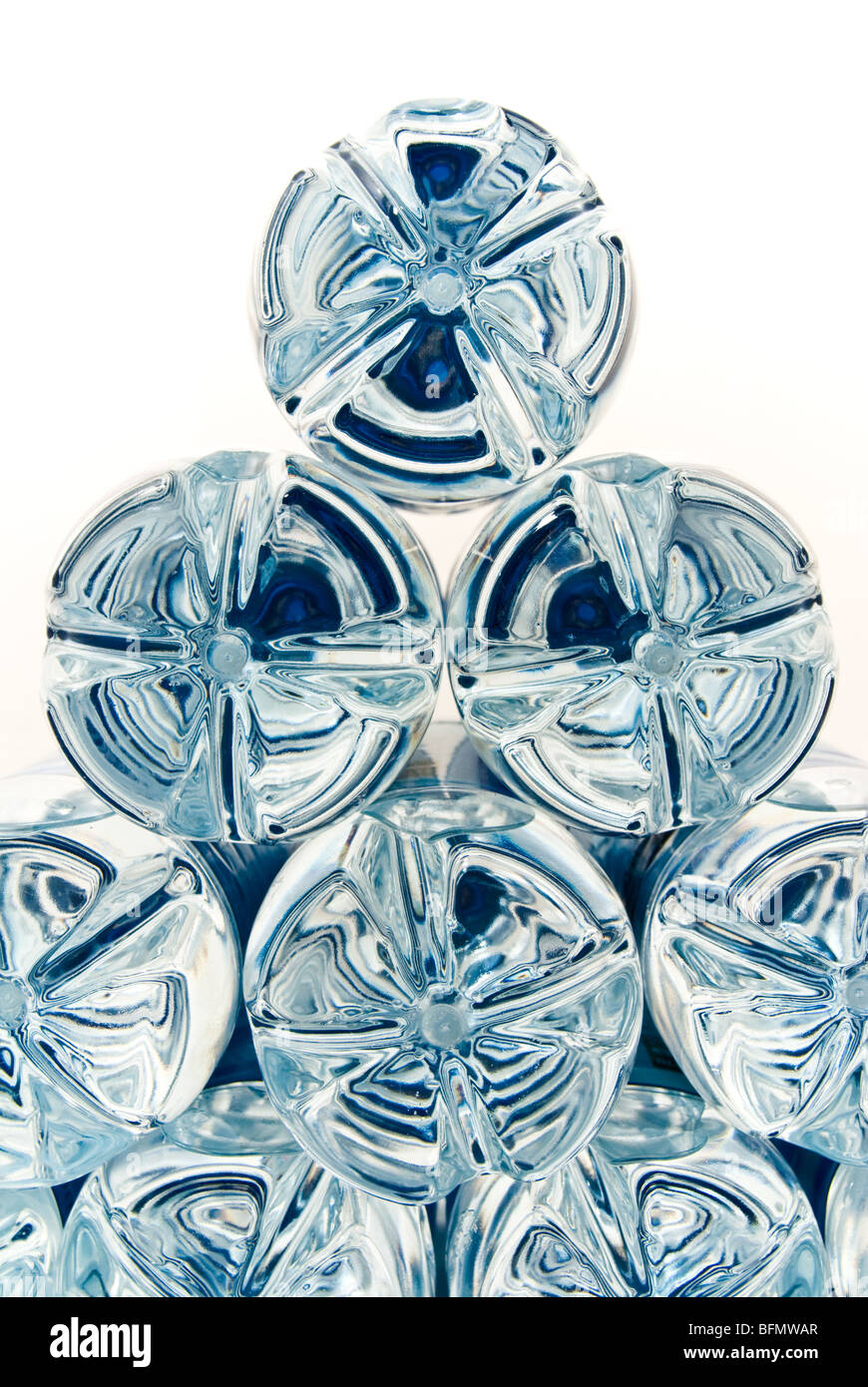 Moulded plastic bottle bottoms with a blue reflection from labels in a triangle formation Stock Photo