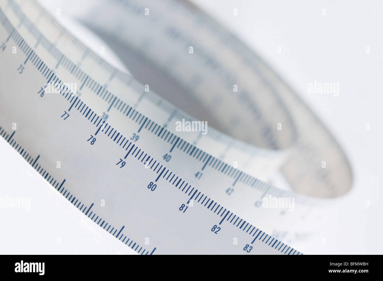 Coiled metric tape measure. Foreground focus. Stock Photo