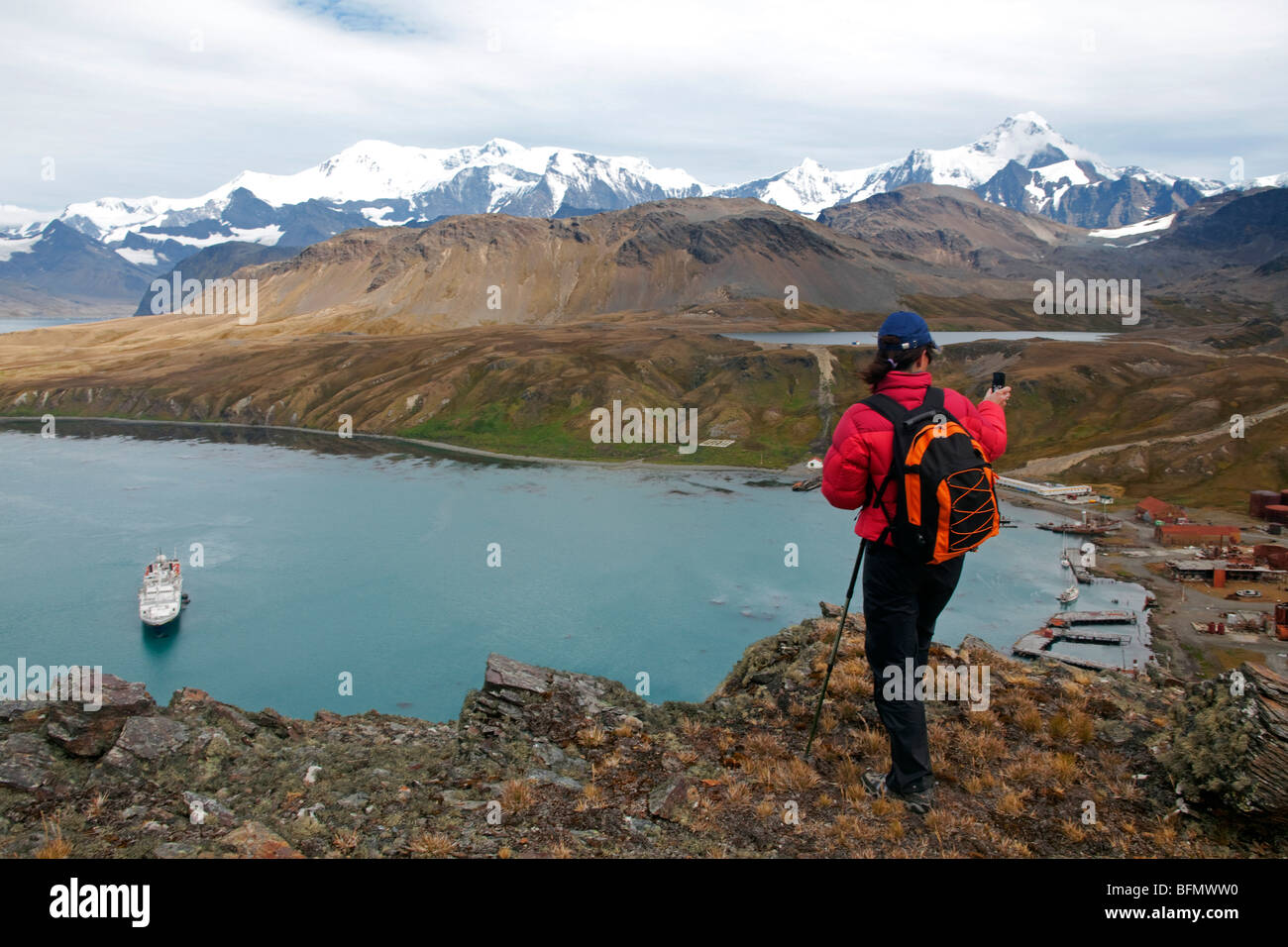 South Georgia and the South Sandwich Islands, South Georgia, Cumberland Bay, Grytviken. Videoing the old Whaling station. (MR) Stock Photo