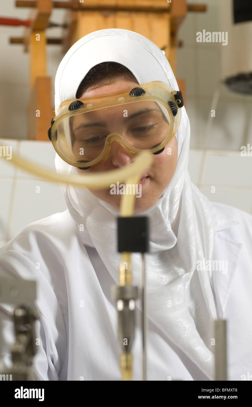 Muslim girl wearing safety goggles inside lab at Beirut Arab University Lebanon Middle East Stock Photo