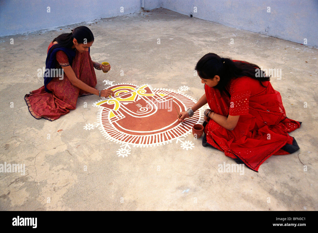 SNS 60879 : Girls doing painting of god Ganesh ganpati ; Mandva ; jaipur ; rajasthan ; india Stock Photo