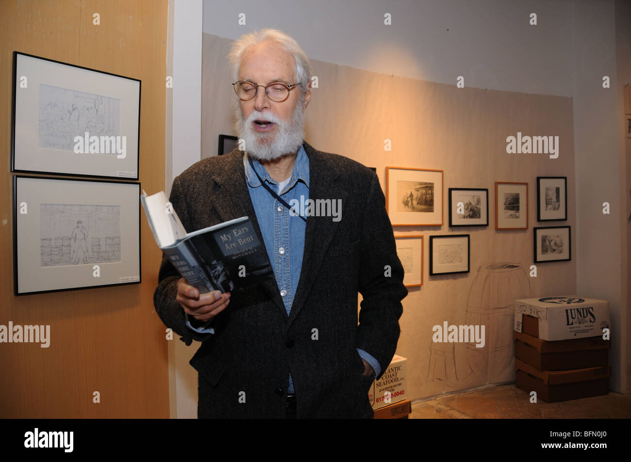 Jack Putnam reading from a book by Joseph Mitchell at an art exhibit about the  Fulton Fish Market, formerly in Lower Manhattan. Stock Photo