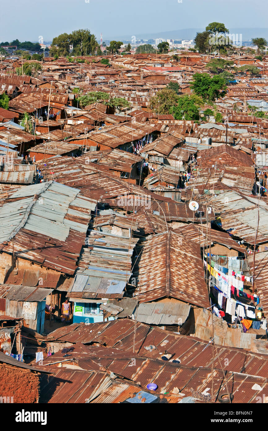 Kenya, Nairobi. A crowded part of Kibera, one of Nairobi  s largest slums, with the city centre visible in the distance Stock Photo