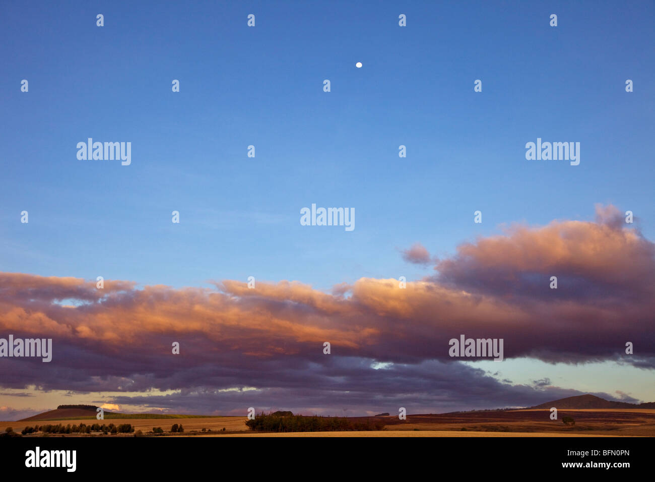 Kenya,Timau. Last light over rolling farmland at Timau with a full moon high in the sky. Stock Photo