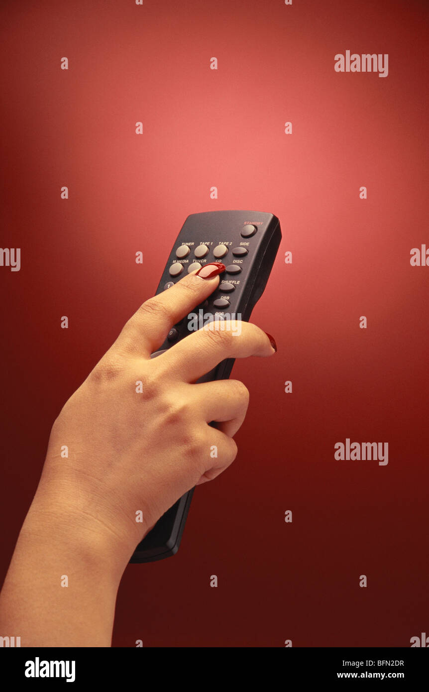 Lady operating TV remote control Stock Photo