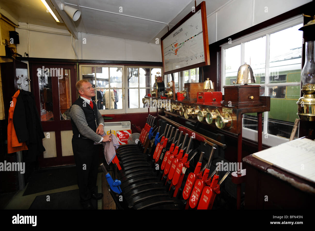 The signalman at work inside the signal box at the Bluebell railway at