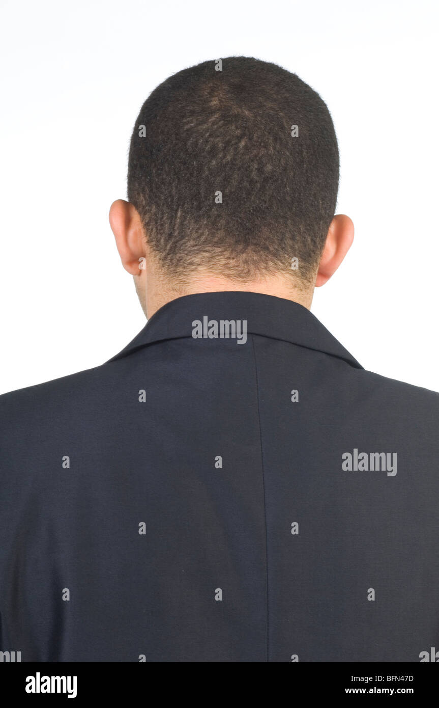 Rear view of a business man wearing a suit against a white background ...