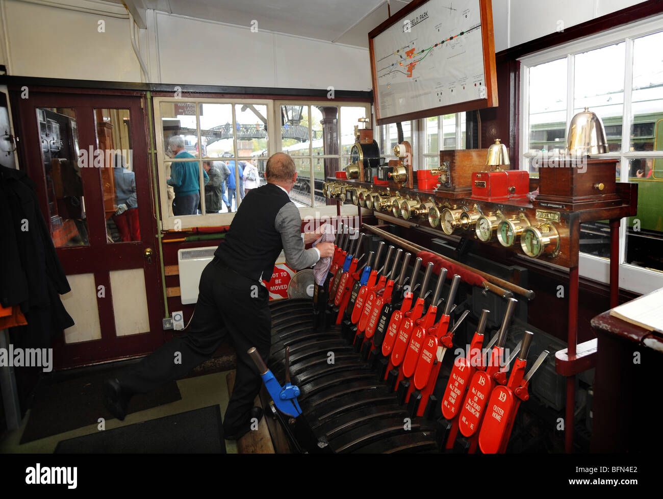 The signalman at work inside the signal box at the Bluebell railway at Sheffield Park in Sussex Stock Photo