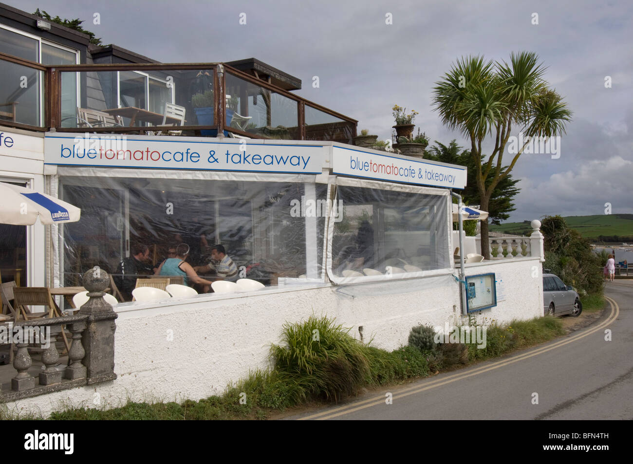 The trendy Blue Tomato Cafe on Rock seafront, on the North Cornwall coast. Stock Photo