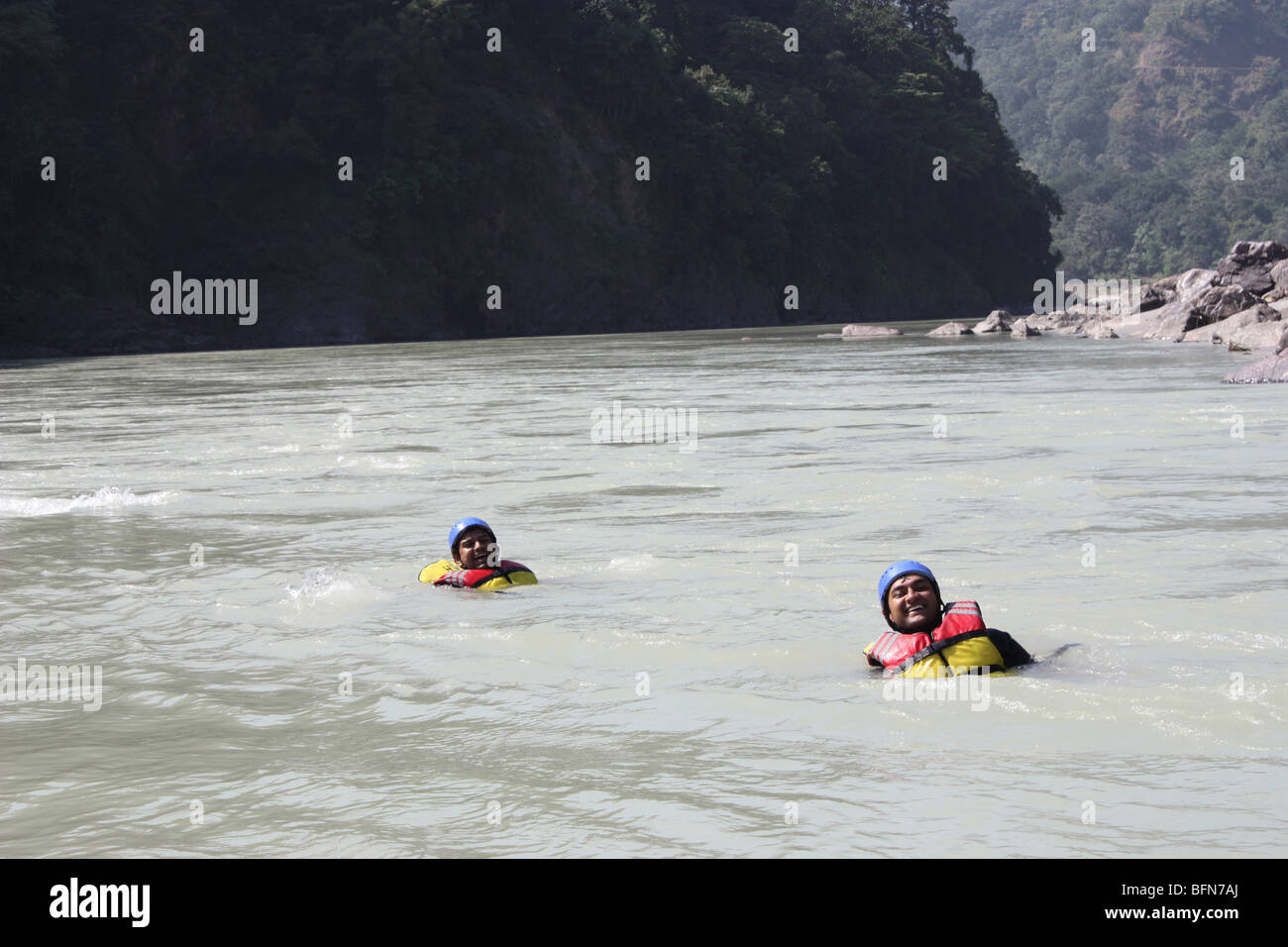 Tourists enjoying Rafting body surfing swimming in Rishikesh in Ganga river Stock Photo