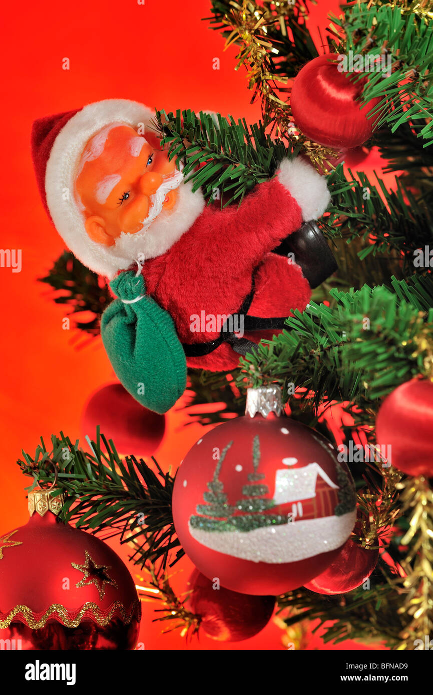 Santa Claus / Father Christmas and bells hanging in tree Stock Photo