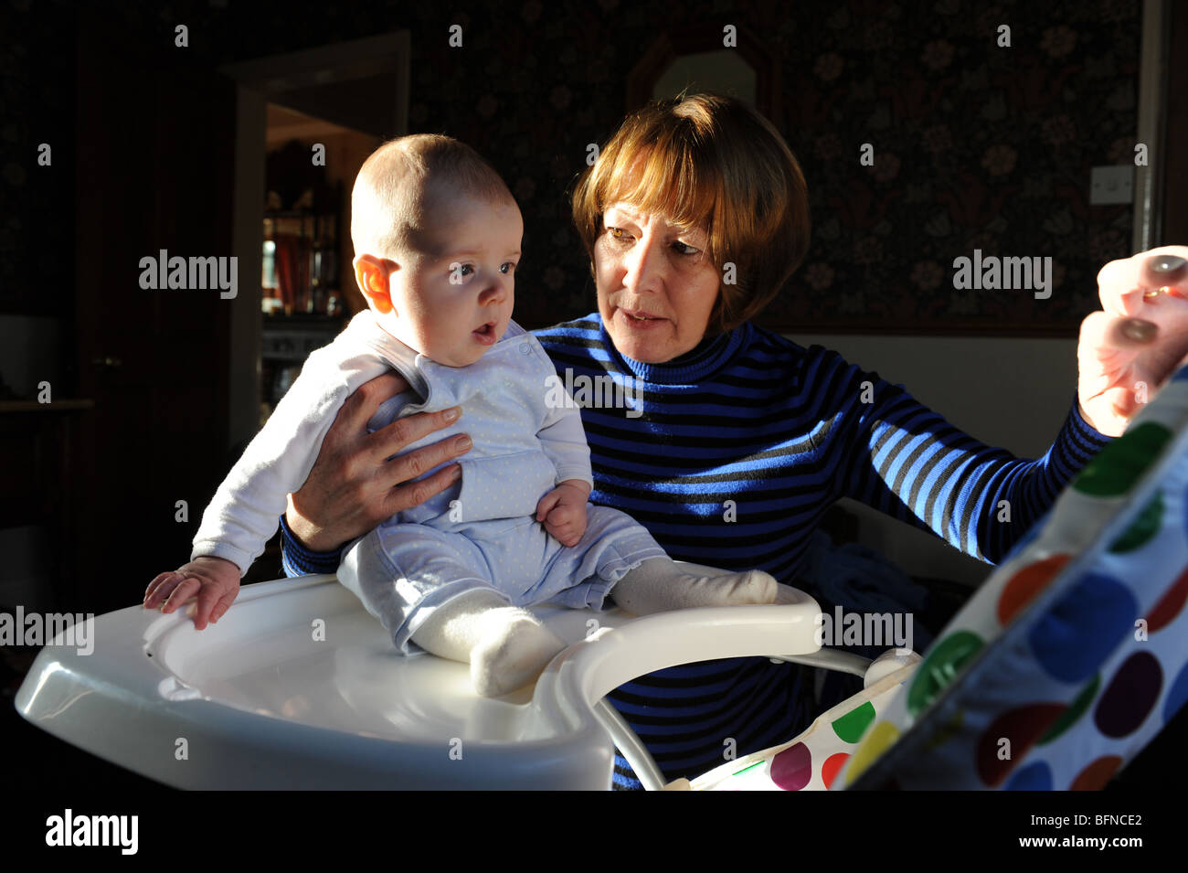 Grandmother entertaining four month old grandson woman and grandchild