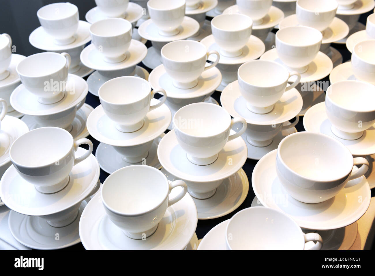 Empty white cups and saucers at conference Stock Photo