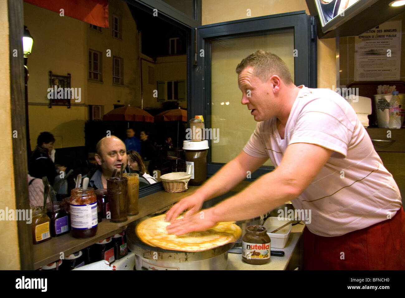 French man making crepes at a Creperie in the Montmartre District of Paris, France. Stock Photo