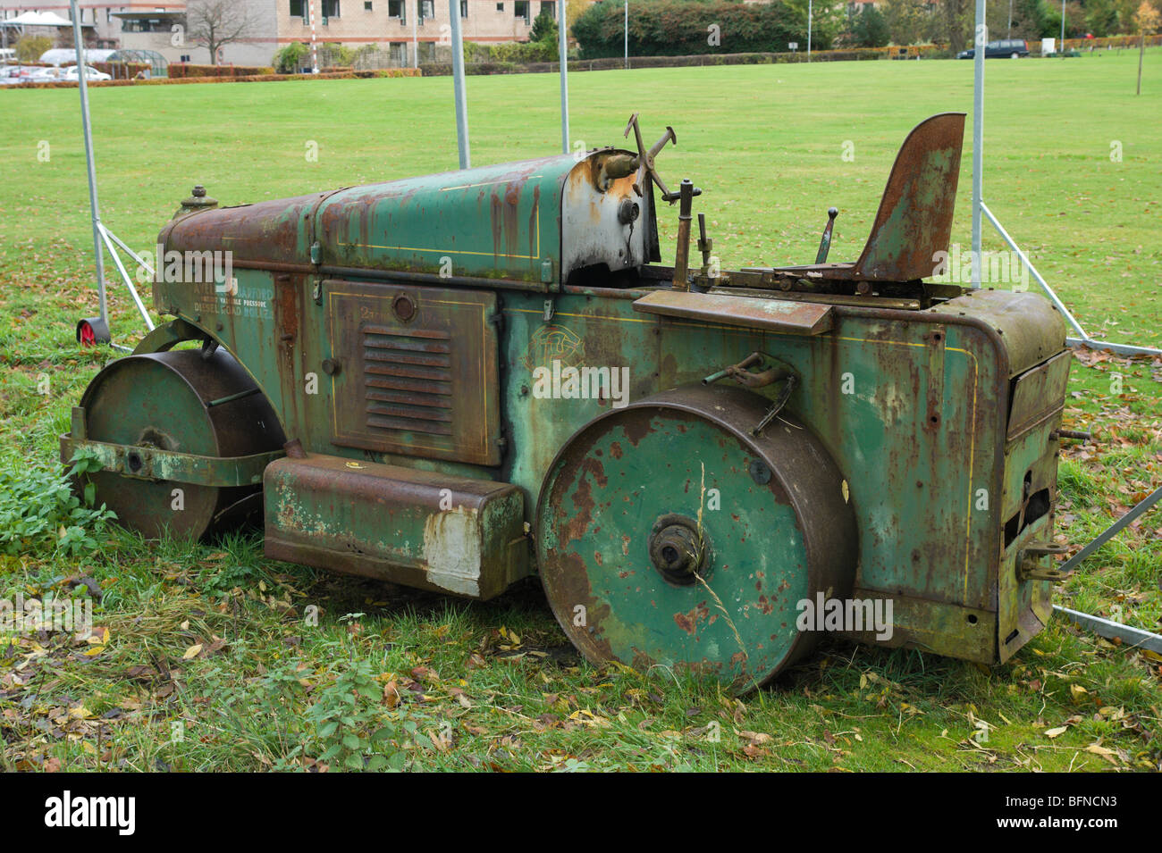 Neglected old diesel road roller on a cricket pitch in Britain Stock Photo
