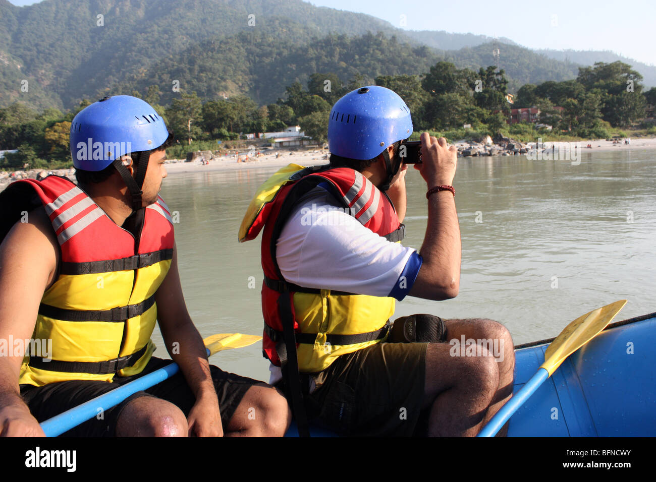 Tourists enjoying the boat ride rafting in Ganga near Rishikesh Stock Photo