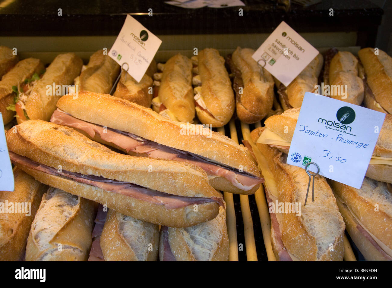 Ham and cheese sandwich in the storefront window of bakeshop in Paris, France. Stock Photo