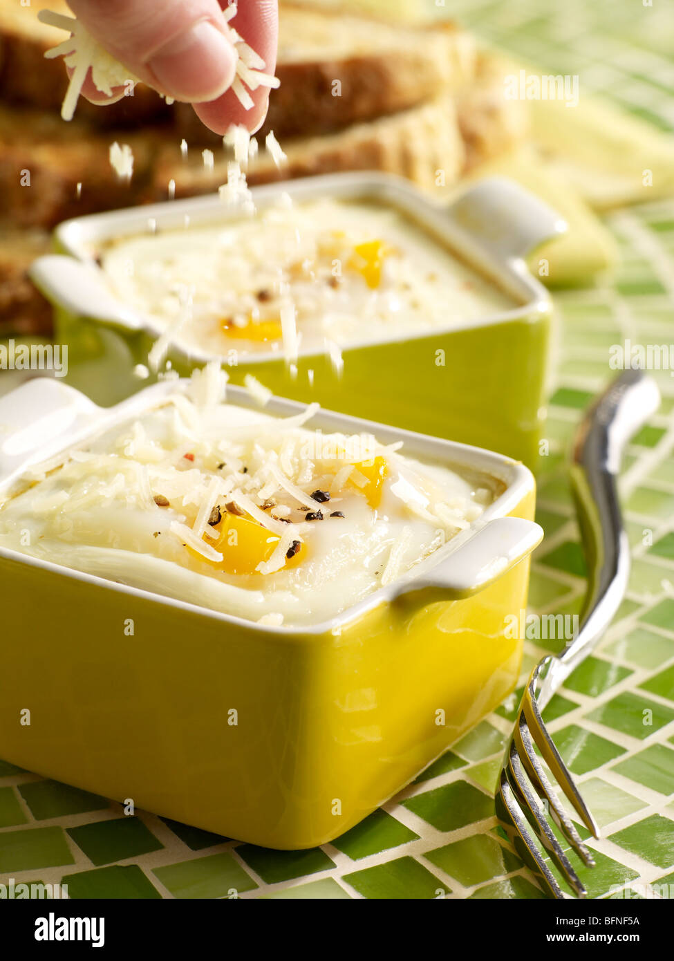 Baked Eggs with Parmesan sprinkling Stock Photo