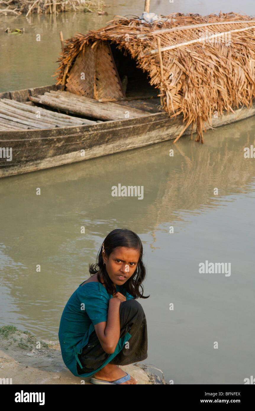 A girl sits waiting for relief supplies after Cyclone Sidr destroyed parts of the Bangladesh delta. Stock Photo