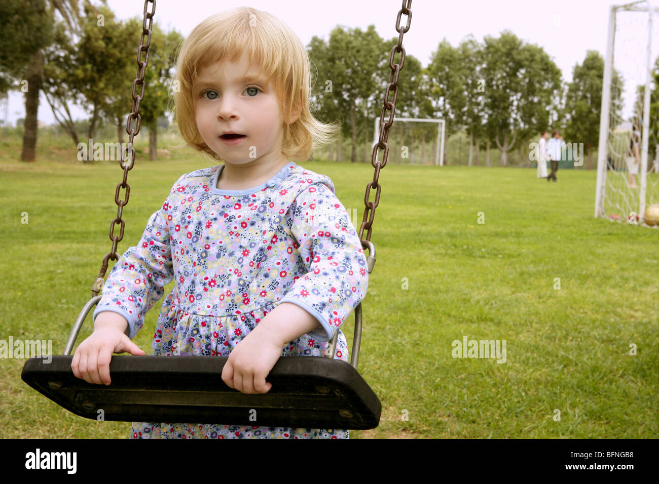 Beautiful toddler blond girl playing on the park playground Stock Photo ...