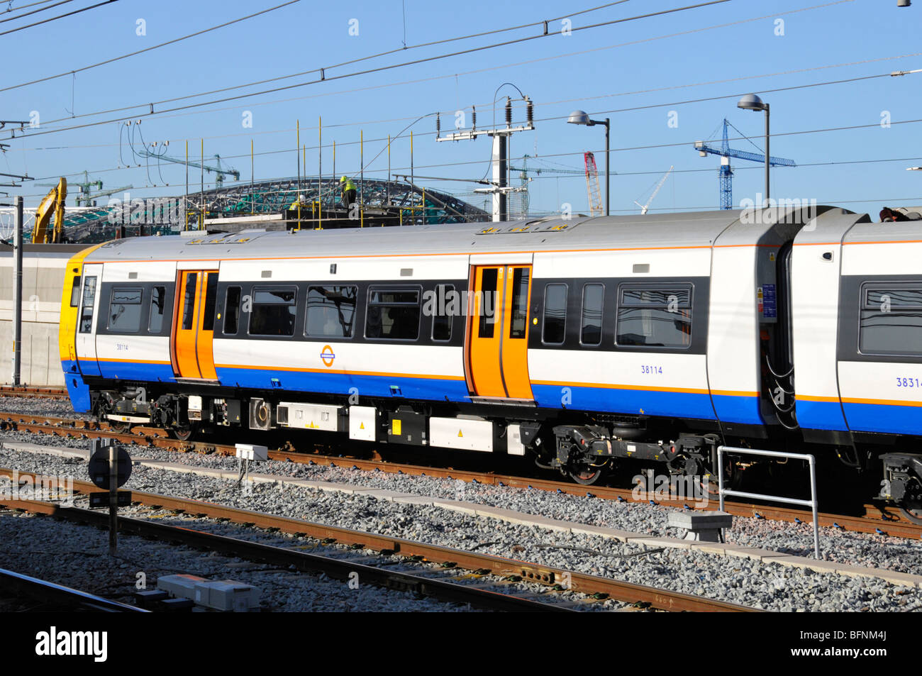 Overground train departing Stratford London passing the 2012 Olympic construction project Stock Photo