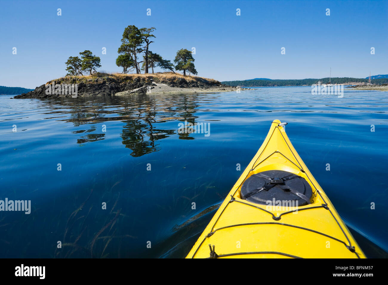 The bow of a sea kayak on the water near Turn Island in the San Juan