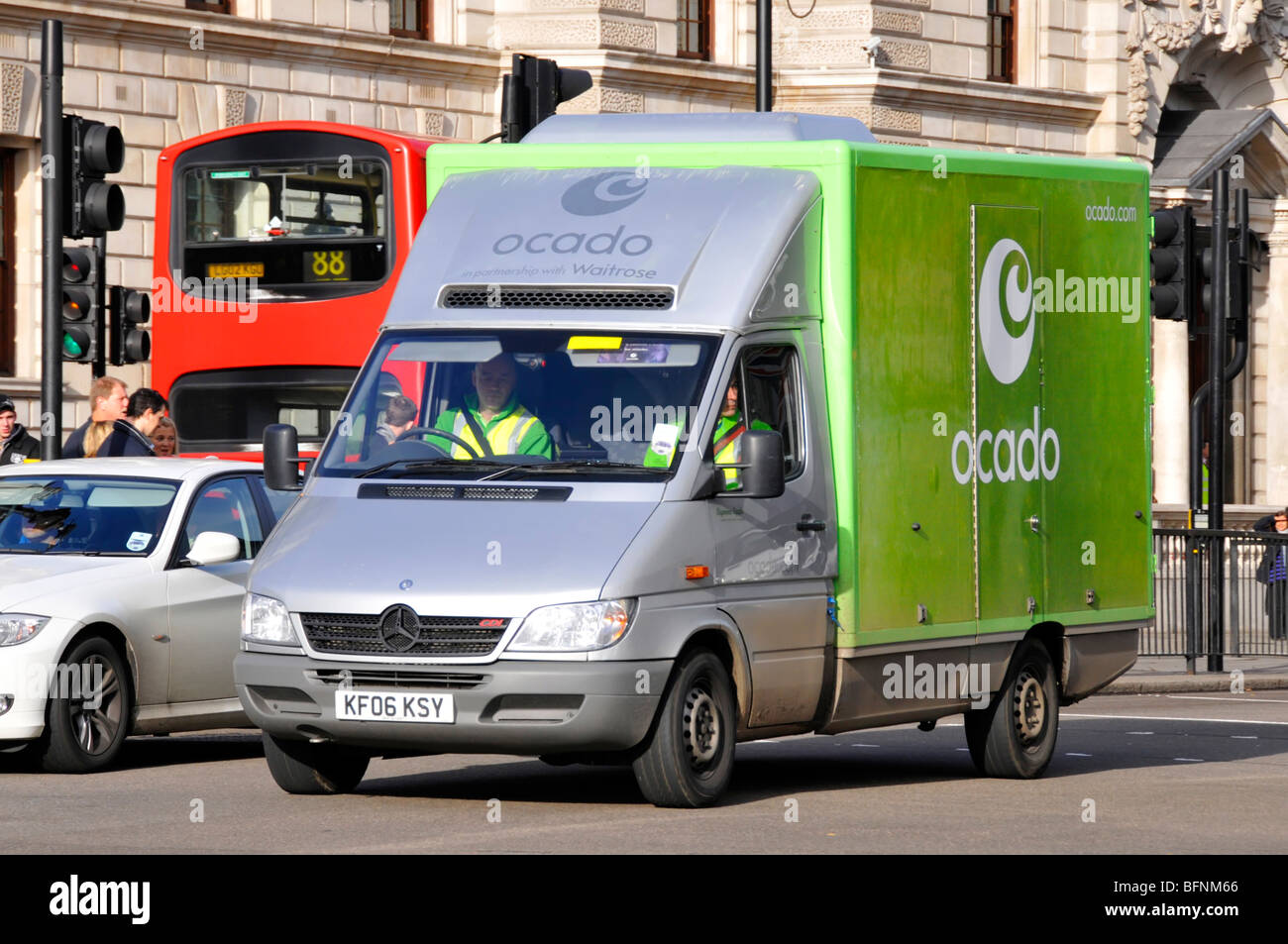Ocado online supermarket business food supply chain grocery delivery van driver and mate driving in Whitehall London England UK Stock Photo