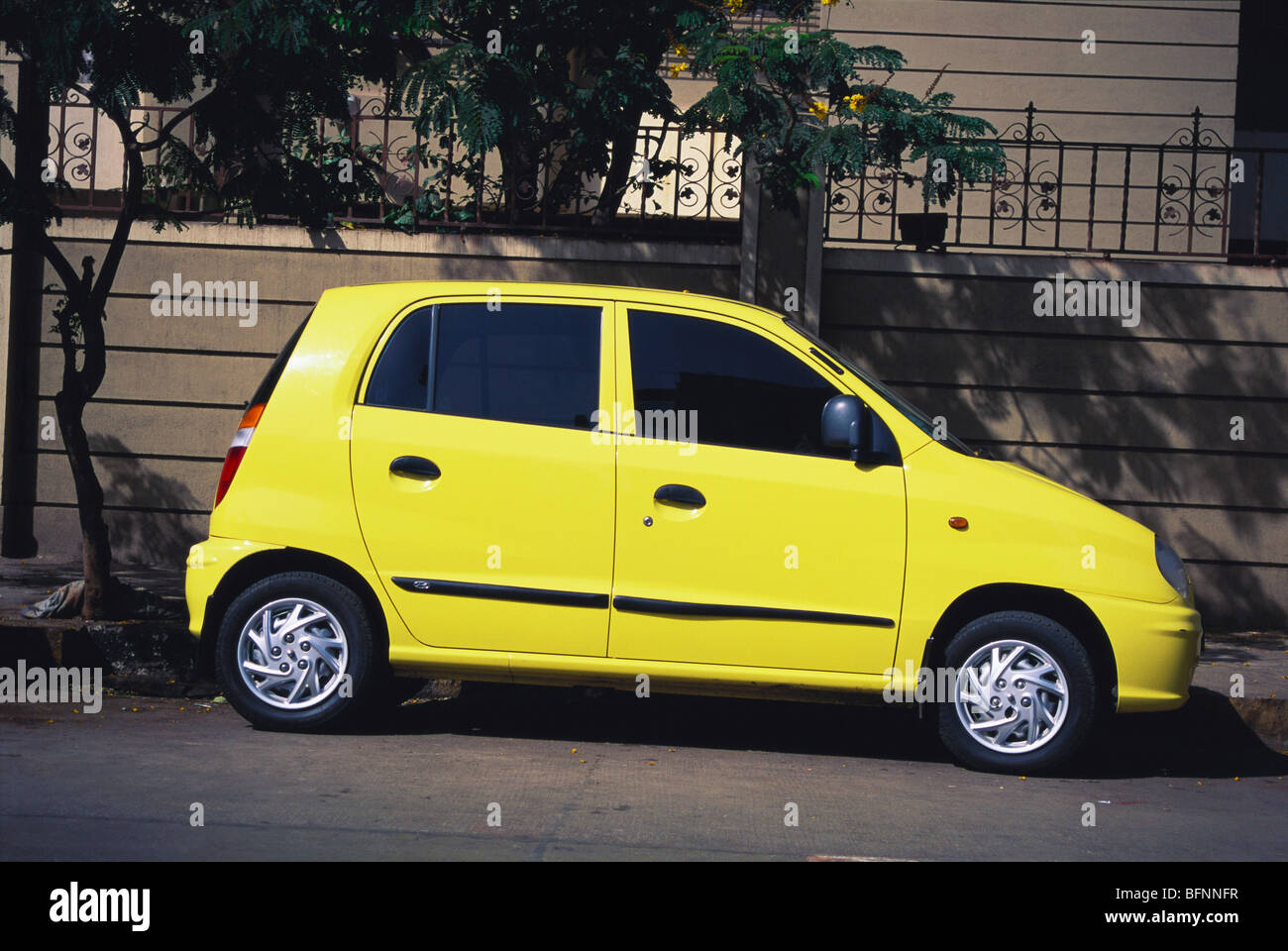 Yellow color car model Santro make Hyundai parked profile ; India ; asia Stock Photo