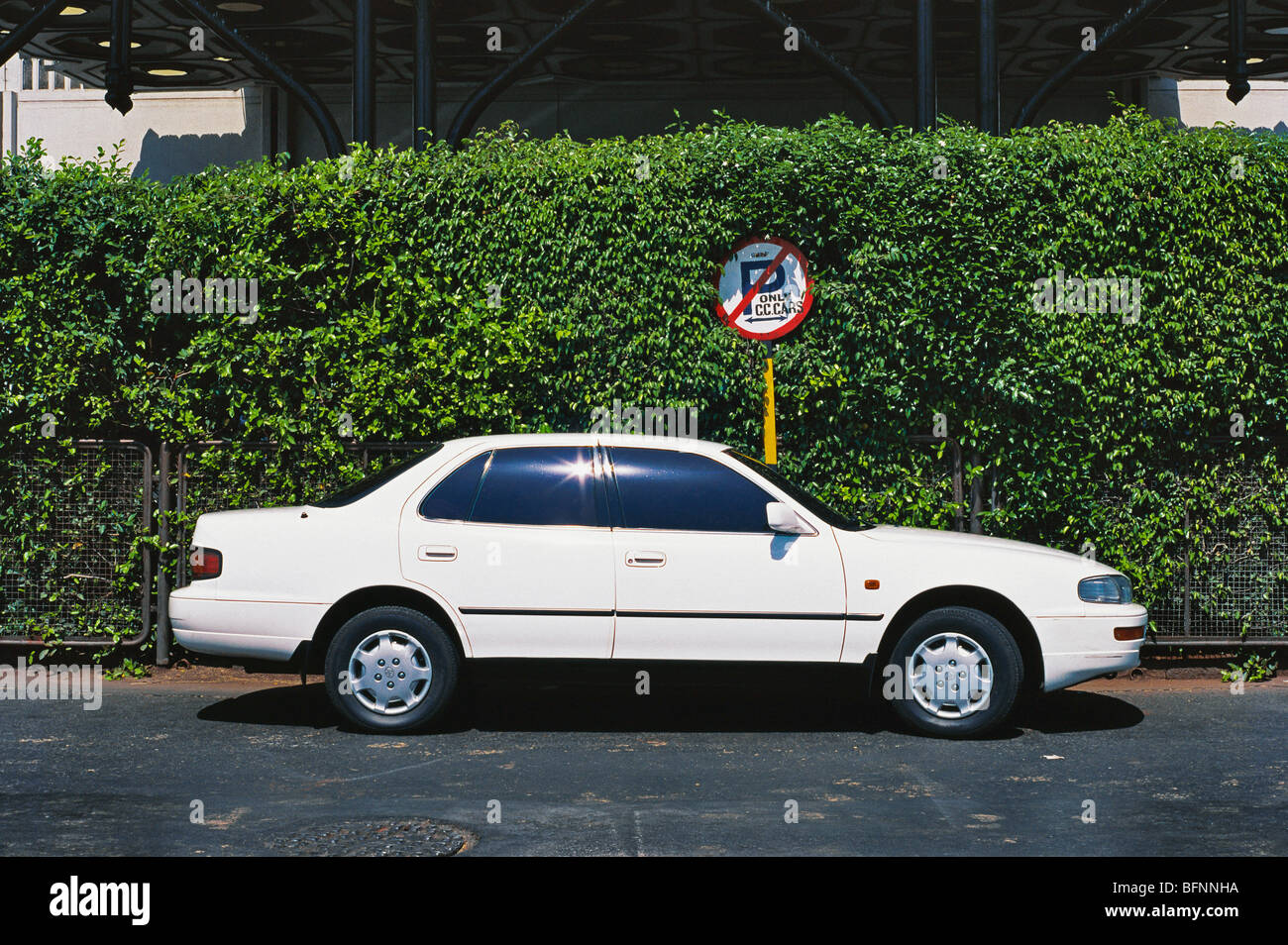 Toyota Camry white car profile at no parking sign Bombay Mumbai Maharashtra India - NMK 62561 Stock Photo