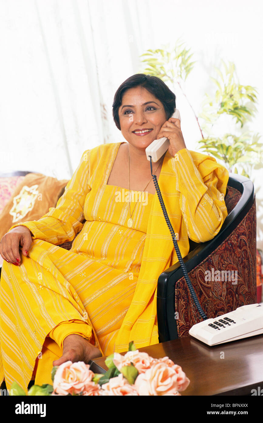 Indian senior woman talking on telephone sitting in house ; MR#449 Stock  Photo - Alamy