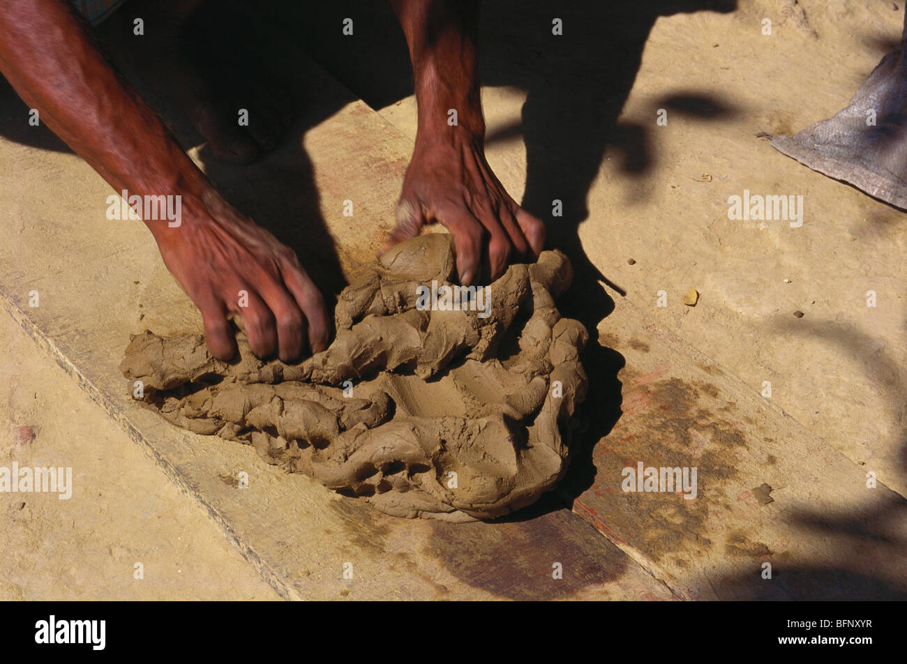 Kneading clay for pottery ; massage and squeeze mud ; varanasi ; Uttar