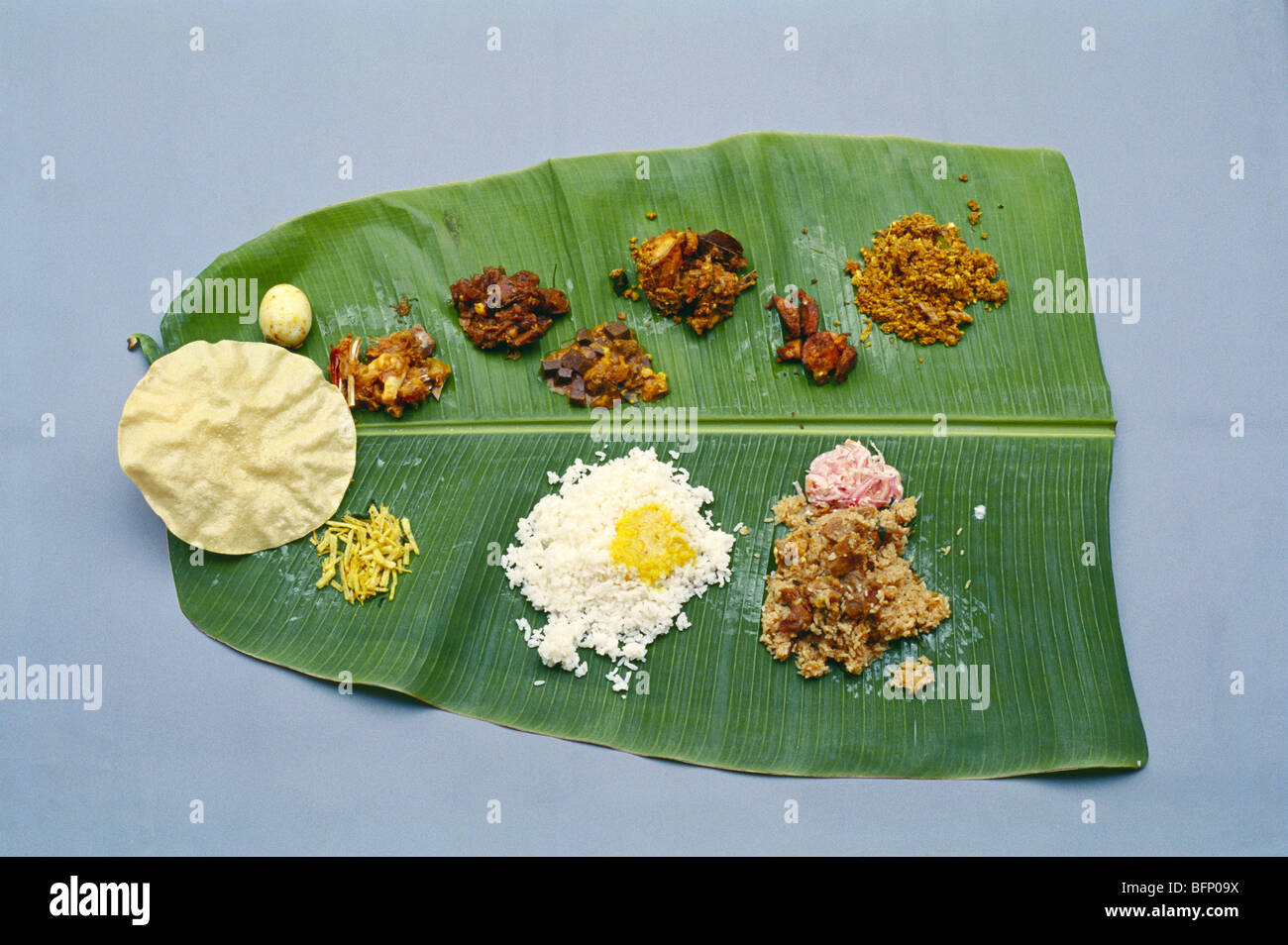 Indian lunch on banana leaf ; Nattukottai Chettiar wedding ; Chettinad ; Sivaganga ; Pudukottai ; Tamil Nadu ; India ; asia Stock Photo