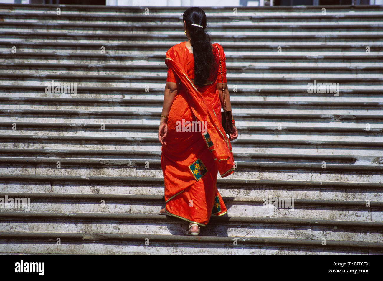 Lady in sari climbing stairs Mumbai India Stock Photo Alamy