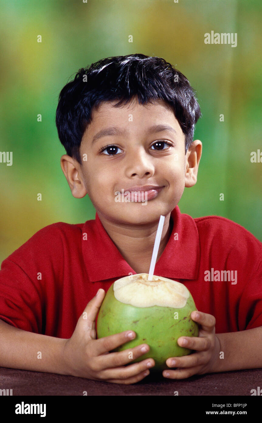 Child drinking coconut water ; India ; asia ; MR#152 Stock Photo