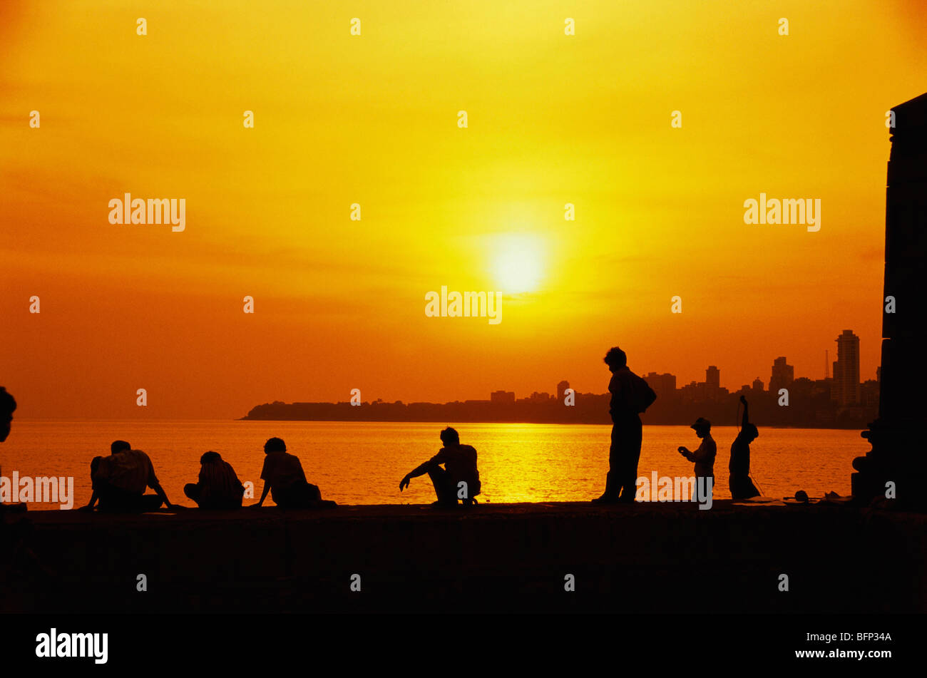 People relaxing ; Parsi Gate ; Marine Drive ; Walkeshwar ; Malabar Hill ; Bombay ;  Mumbai ; Maharashtra ; India ; asia Stock Photo