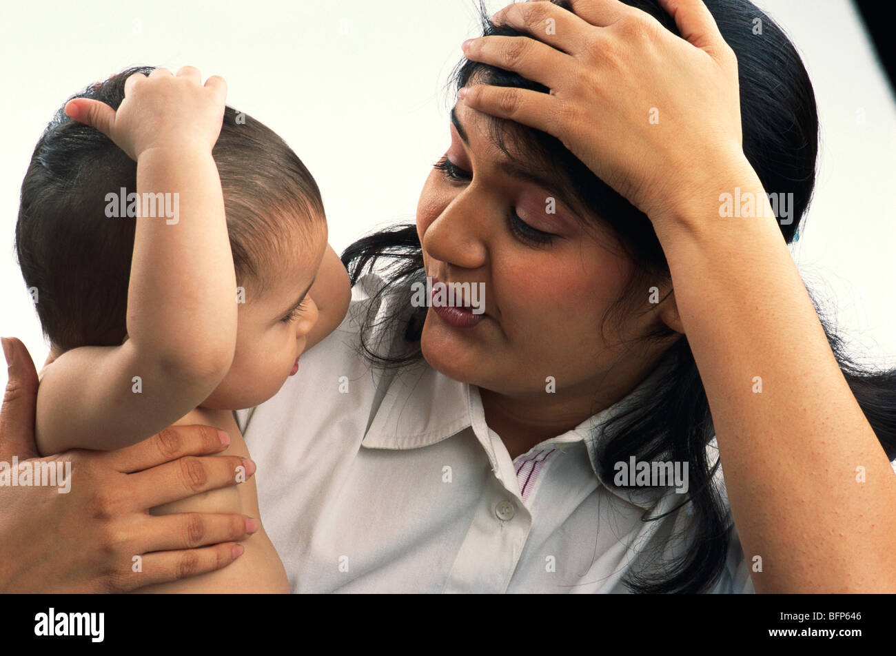 Mother and child baby imitating mom keeping hand on head MR#592&593 Stock Photo