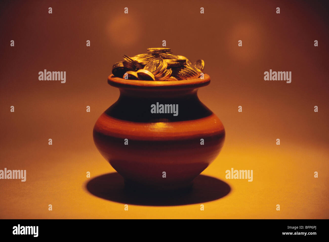 Saving pot and coins Stock Photo - Alamy