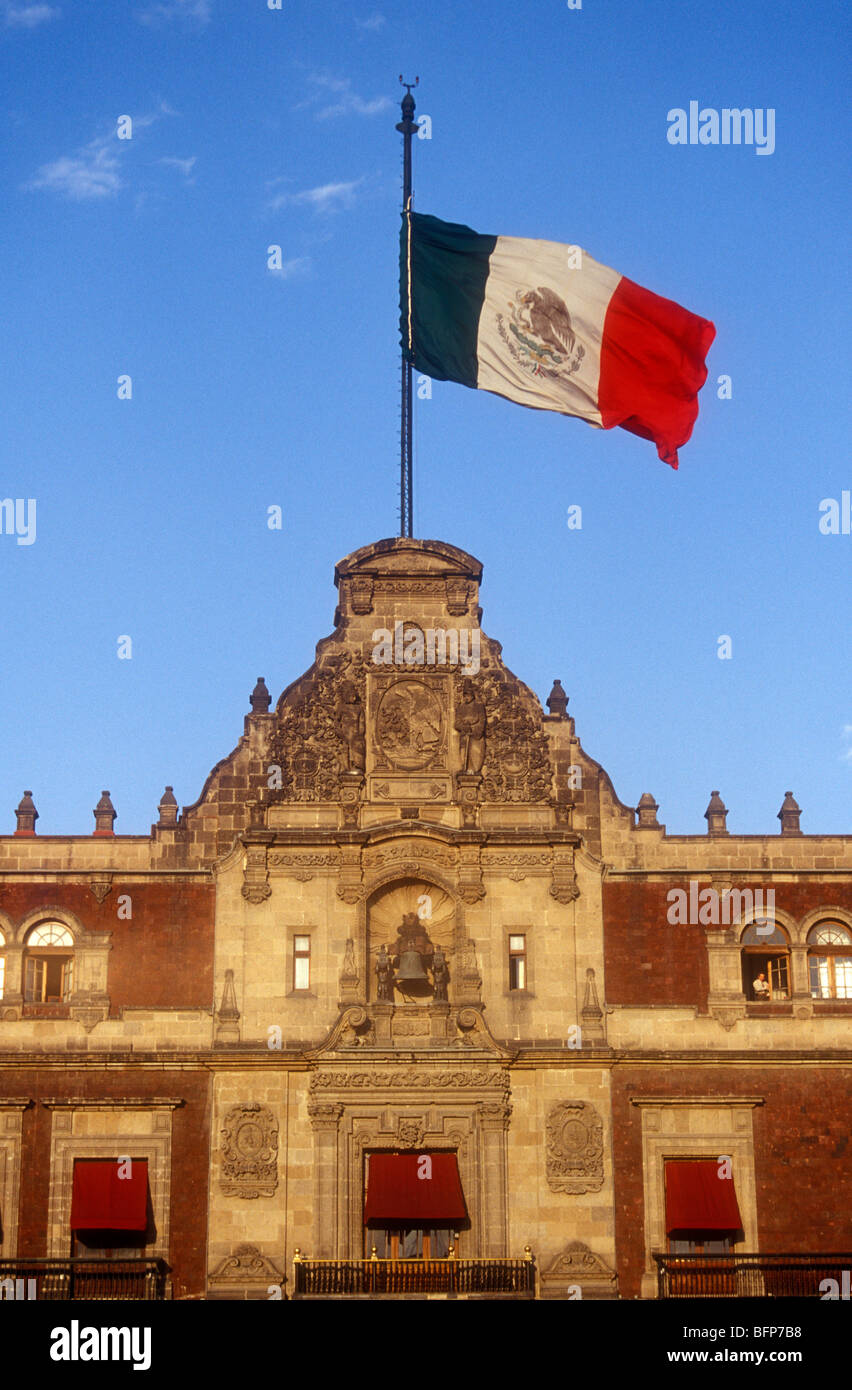 Mexican flag flying above the National Palace or Palacio Nacional on the Zocalo in Mexico City Stock Photo