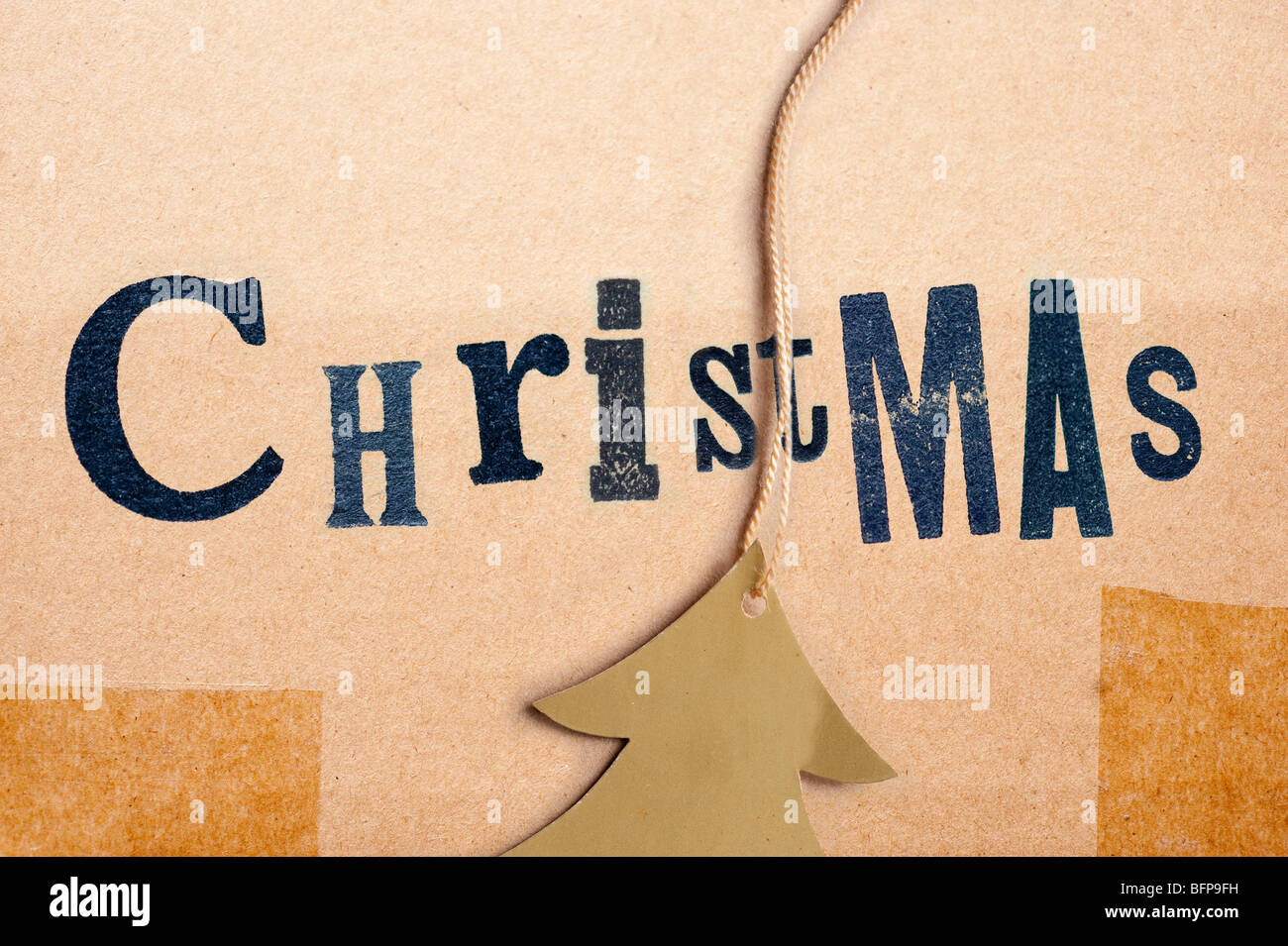 Christmas, old lettering on brown parcel with gold christmas tree label