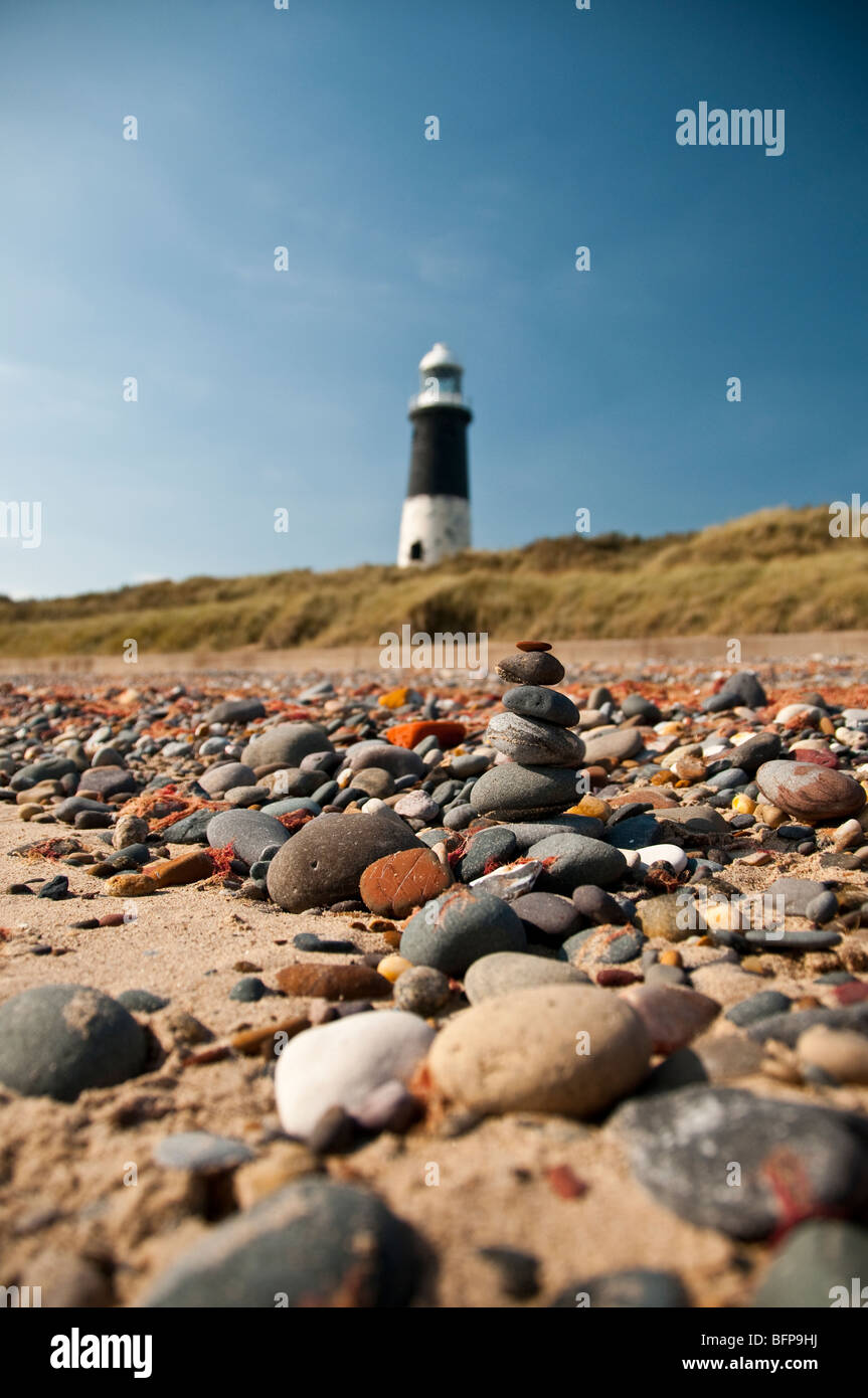 Short stone tower mimicing the Old Spurn Head Lighthouse in the background. Stock Photo